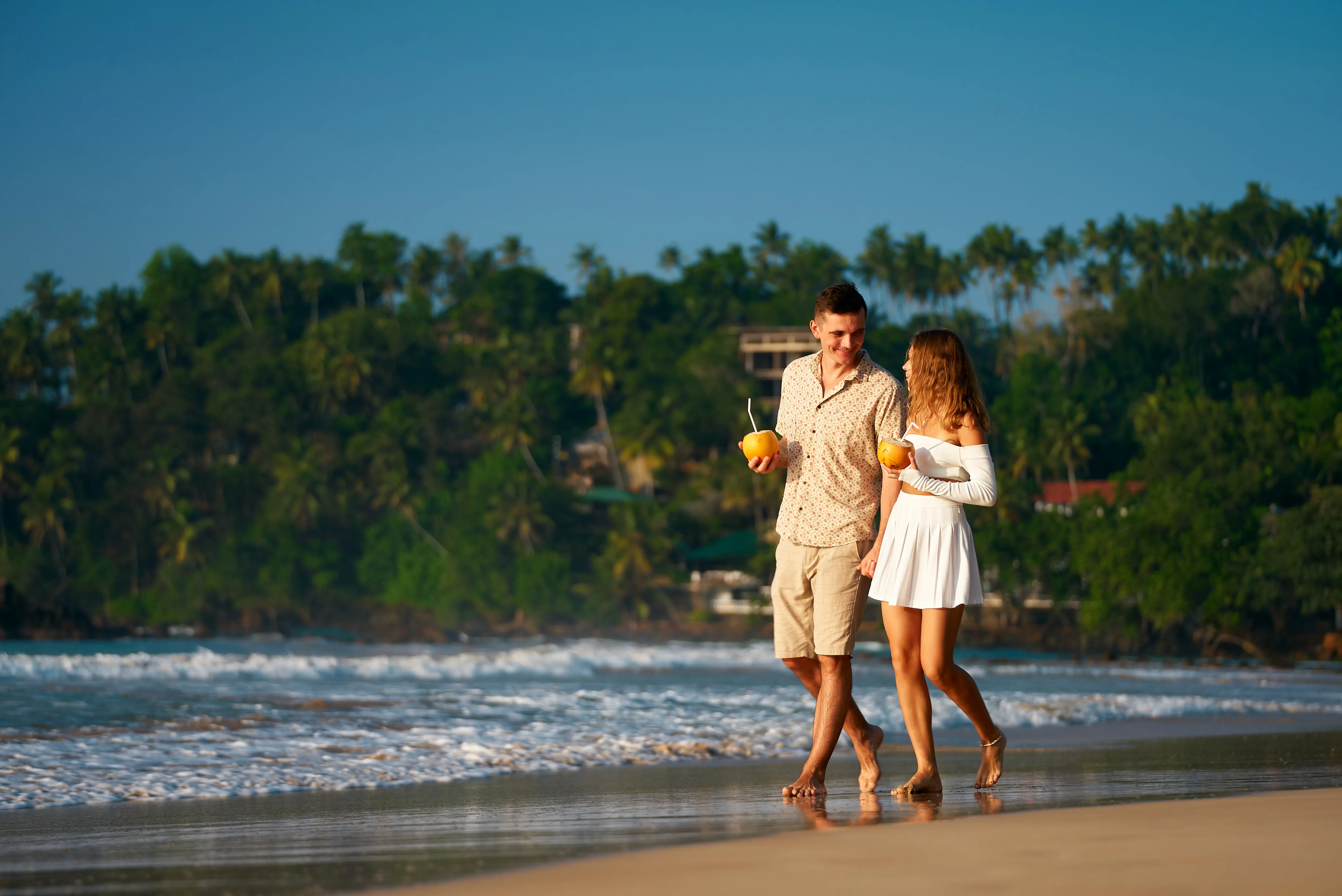 romantic-couple-walk-sandy-beach-man-woman-hold-tropical-drinks-stroll-by-sea-sunset